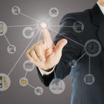 Businessman pointing out with business icons overlay